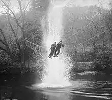 Commandos on a toggle rope bridge.